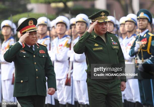 Russia's Defence Minister Sergey Shoygu and his Vietnamese counterpart Ngo Xuan Lich review an honour guard during a welcome ceremony at the Ministry...