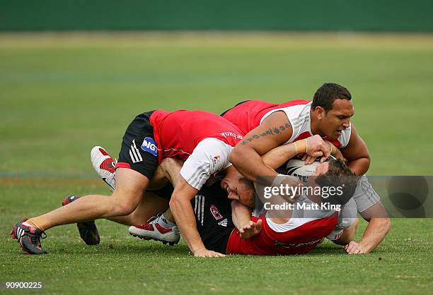 Dean Young is tackled by Ben Hornby and Neville Costigan during a St George Illawarra Dragons NRL training session held at WIN Jubilee Stadium on...