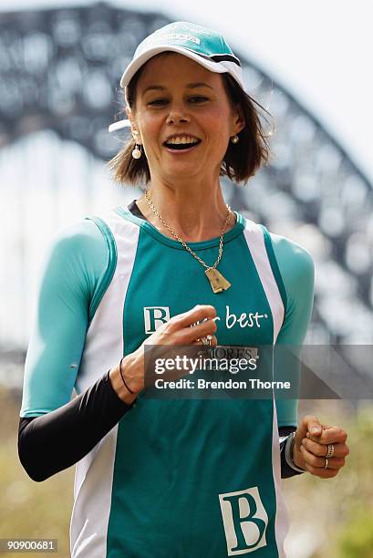 Antonia Kidman runs during a photo call ahead of Sunday's Blackmores Sydney Running Festival, welcoming the official race starter Japan's Naoko...