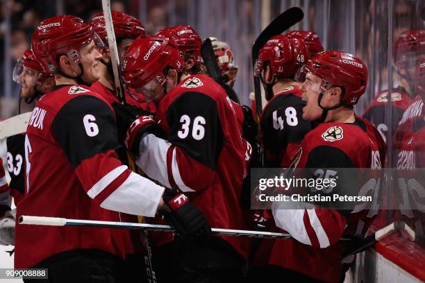 Nick Cousins of the Arizona Coyotes celebrates with Jakob Chychrun Christian Fischer and Jordan Martinook after Cousins scored the game winning...