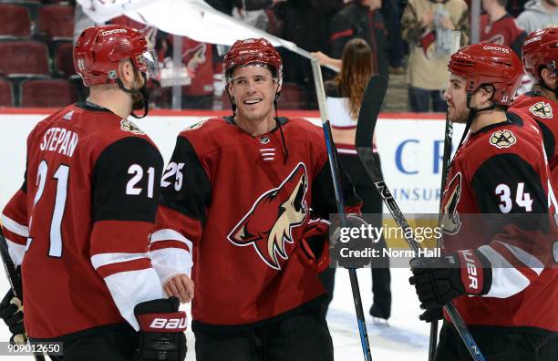 Nick Cousins of the Arizona Coyotes is congratulated by teammates Derek Stepan and Zac Rinaldo after a 3-2 overtime victory against the New York...