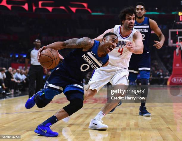 Jeff Teague of the Minnesota Timberwolves drives on Milos Teodosic of the LA Clippers during the first half at Staples Center on January 22, 2018 in...