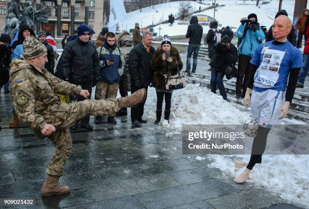 Ukrainian serviceman kicks a ball at a mannequin depicting Russian President Vladimir Putin dressed in a football uniform, during the &quot;Stop...