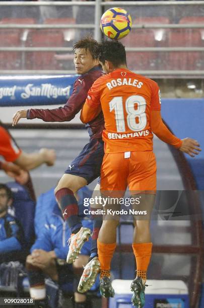 Eibar's Takashi Inui and Malaga's Roberto Rosales vie for the ball during the second half of a Spanish La Liga match at Estadio Municipal de Ipurua...