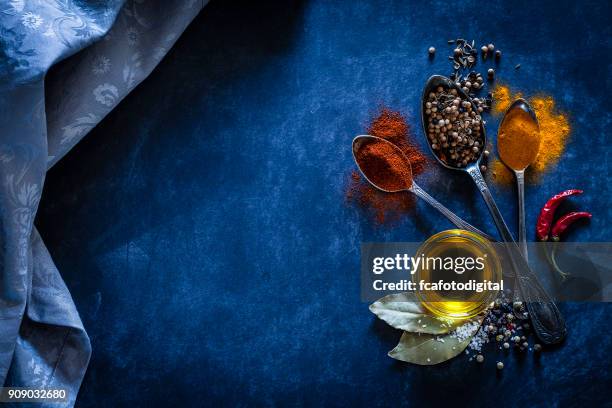 spices background on bluish tint kitchen table - food photography dark background blue stock pictures, royalty-free photos & images