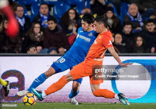 Gaku Shibasaki of Getafe CF competes for the ball with Federico Ricca Rostagnol of Malaga CF during the La Liga 2017-18 match between Getafe CF and...