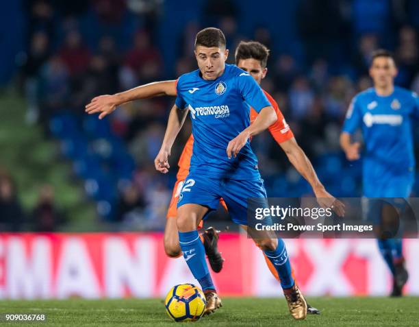 Francisco Portillo Soler of Getafe CF competes for the ball with Adrian Gonzalez Morales of Malaga CF during the La Liga 2017-18 match between Getafe...