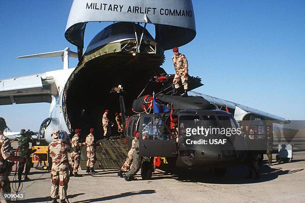 Egyptian and U.S. Troops unload a CH-3 Jolly Green Giant helicopter from a C-5 Galaxy aircraft during Exercise Bright Star ''82.