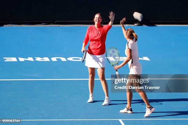 Lindsay Davenport of the United States and Iva Majoli of Croatia celebrate winning a point in their legend's doubles match against Nicole Bradtke of...