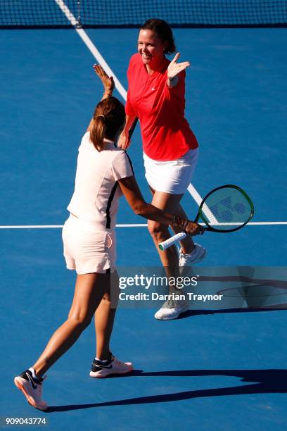 Lindsay Davenport of the United States and Iva Majoli of Croatia celebrate winning a point in their legend's doubles match against Nicole Bradtke of...