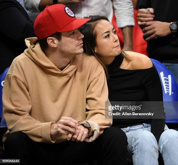 Actor Grant Gustin and Andrea "LA" Thoma attend a basketball game between the Los Angeles Clippers and the Minnesota Timberwolves at Staples Center...