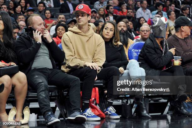 Actor Grant Gustin and Andrea "LA" Thoma attend a basketball game between the Los Angeles Clippers and the Minnesota Timberwolves at Staples Center...