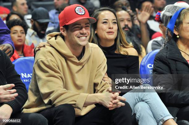 Actor Grant Gustin and Andrea "LA" Thoma attend a basketball game between the Los Angeles Clippers and the Minnesota Timberwolves at Staples Center...