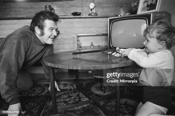 Liverpool goalkeeper Tommy Lawrence playing with his young son Stephen aged two and a half at the family home. February 1970.