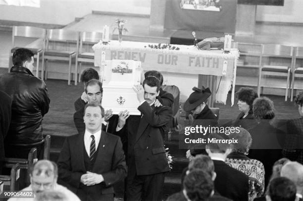 The funeral of James Bulger, Sacred Heart Church, Kirkby . Ralph Bulger helps carry the coffin as his wife Denise follows, 1st March 1993.