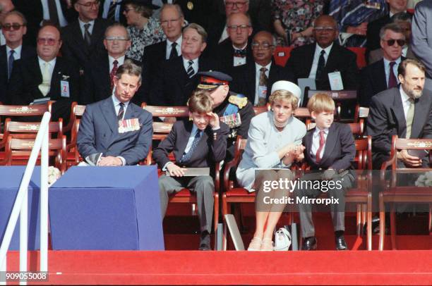 Prince Charles, Prince William, Diana Princess of Wales holding the hand of her son Prince Harry at a ceremony in Hyde Park, London, marking the 50th...