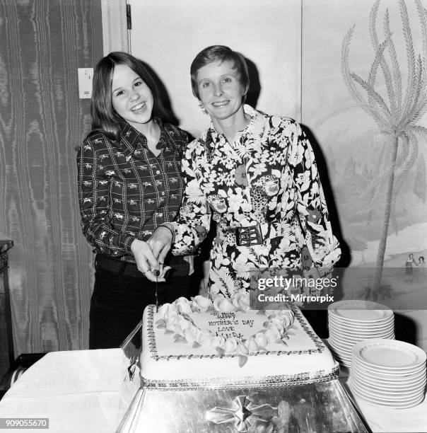 Linda Blair, aged 15, who is the child star of the film 'The Exorcist'. Pictured with her mother Eleanor. Linda helps her mother to cut a Mother's...