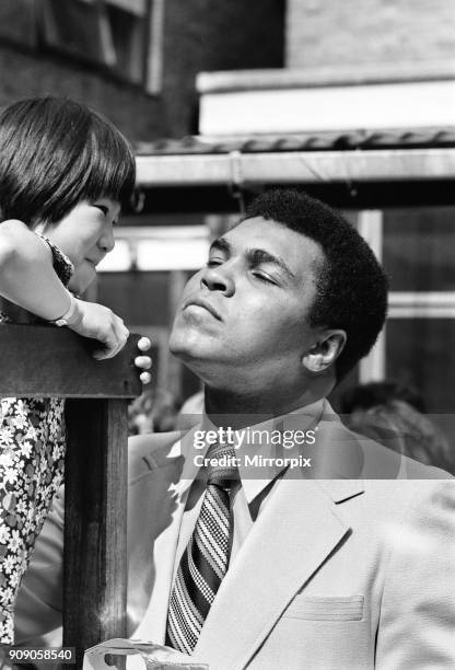 World Heavy-weight boxing champion Muhammad Ali with a little girl from Great Ormond Street the Hospital for sick children. 11th August 1977.