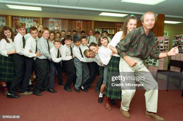 Jasper Carrott receives the £2000 cheque for Comic Relief from pupils at Sir Wilfred Martineau School in Tile Cross, 8th July 1991.