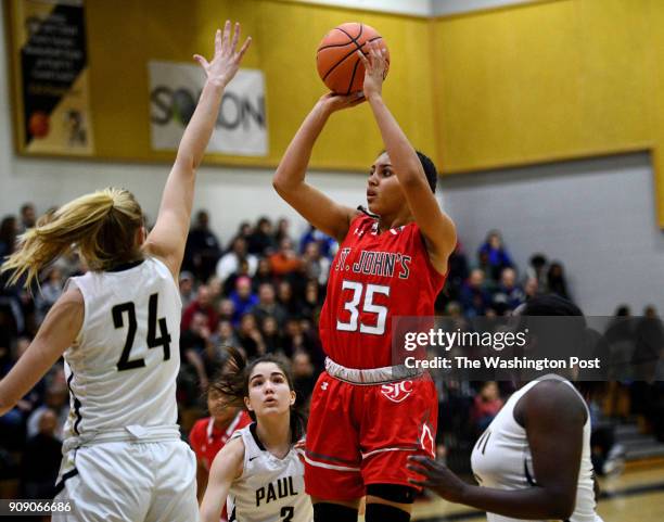 St. John's Cadets Azzi Fudd shoots over Paul VI Panthers guard Kate Klimkiewicz in the first half January 03, 2018 in Fairfax, VA. Fudd scored 27...