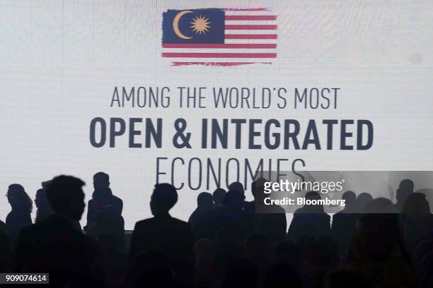 The silhouettes of attendees are seen in front of a screen at the Invest Malaysia conference in Kuala Lumpur, Malaysia, on Tuesday, Jan. 23, 2018....