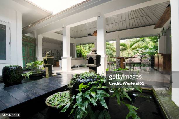 atrium and open living area in tropical home - atrio fotografías e imágenes de stock