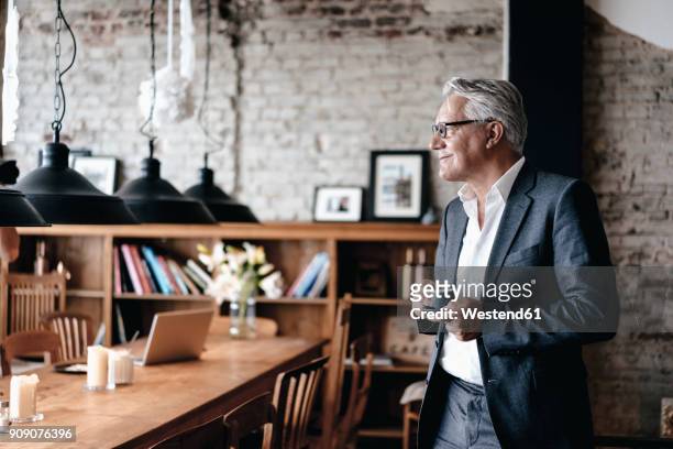 senior businessman drinking coffee, smiling - business owner suit fotografías e imágenes de stock