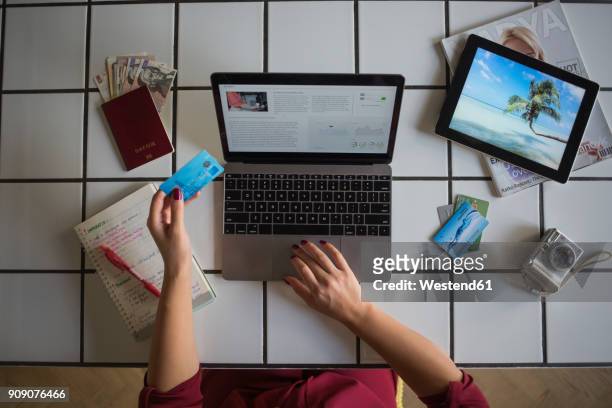 young woman using laptop, paying with credit card, travel booking - planning vacations stock pictures, royalty-free photos & images