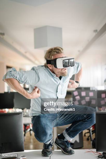 businessman wearing vr glasses in office pretending to be a monkey - monkey wearing glasses fotografías e imágenes de stock