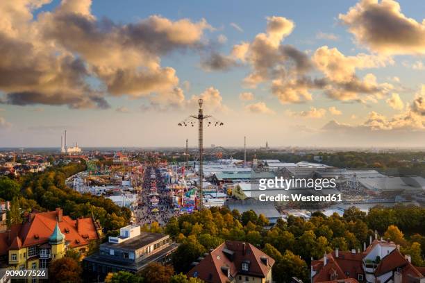 germany, bavaria, munich, view of beer fest fair on theresienwiese in the evening - oktoberfest fotografías e imágenes de stock