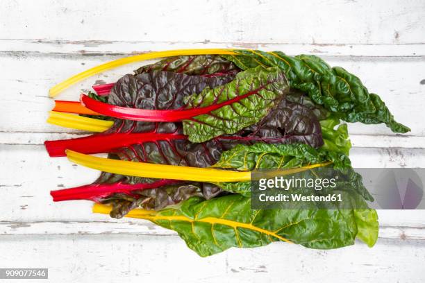 organic mangold on white wood - chard stock pictures, royalty-free photos & images