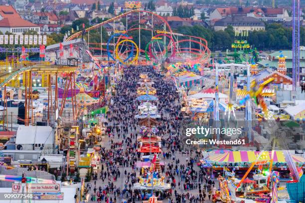 germany, bavaria, munich, view of beer fest fair on theresienwiese in the evening - theresienwiese stock pictures, royalty-free photos & images