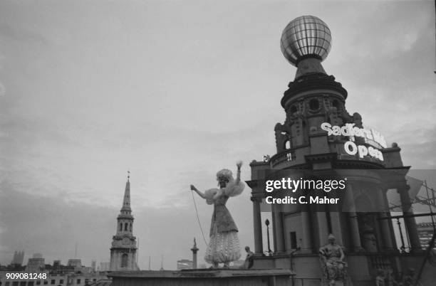 Ballet dancer Susan Hunt light up London Coliseum's globe after repairs, London, UK, 16th October 1968.