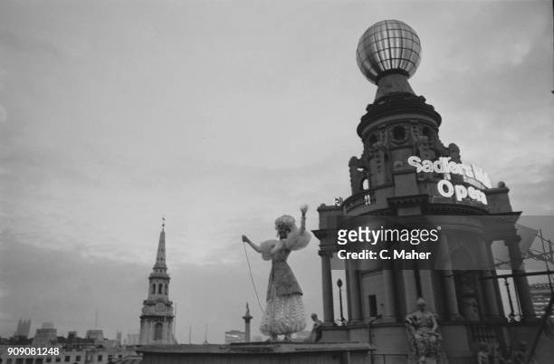 Ballet dancer Susan Hunt light up London Coliseum's globe after repairs, London, UK, 16th October 1968.