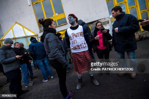 Prison guards, one wearing a jersey with the inscription "Neither Whore nor Doormat" gather for a protest outside the Strasbourg-Elsau prison on...