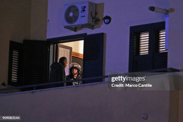 Police men on the balcony of the house from which a man, after killing his wife, started shooting people from the balcony.