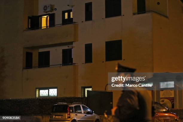 Police forces guard, under the house from which a man, after killing his wife, started shooting people from the balcony.