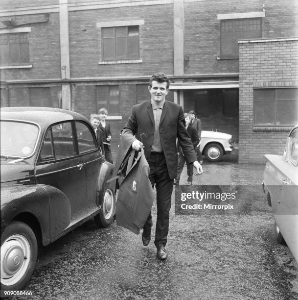 Liverpool goalkeeper Tommy Lawrence picks up his new suit ahead of the team's tour of the USA. 21st April 1964.