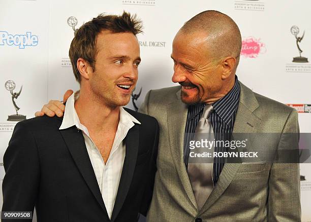 Actors Bryan Cranston and Aaron Paul pose together as they arrive for the 61st Primetime Emmy Awards outstanding performance nominees reception in...