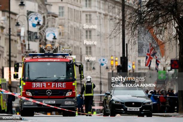 Fire brigade personnel work at the scene of a gas leak on the Strand in central London on January 23, 2018. Almost 1,500 people were evacuated from a...