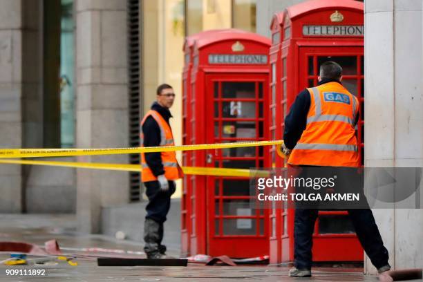 Emergency services and utilities personnel work at the scene of a gas leak on The Strand in central London on January 23, 2018. Almost 1,500 people...