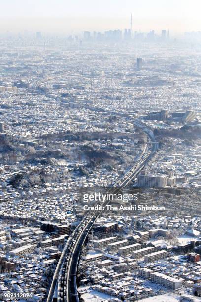 In this aerial image, a long line of cars and trucks are seen on the Chuo Expressway on January 23, 2018 in Chofu, Tokyo, Japan. The snowstorm...
