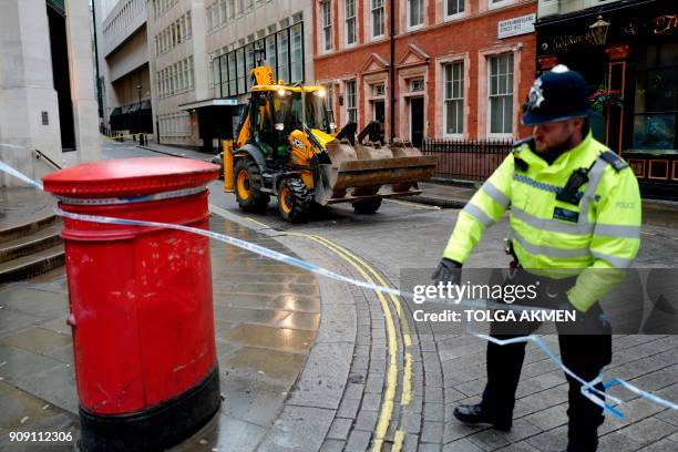 Heavy machinery is seen inside a police cordon on a street adjoining The Strand after the main road was closed because of a gas leak in central...