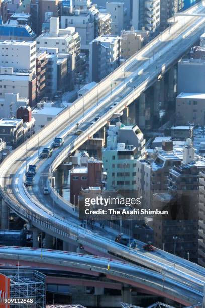 In this aerial image, snow removing operation continues at the Shuto Expressway Ryogoku Junction on January 23, 2018 in Tokyo, Japan. The snowstorm...