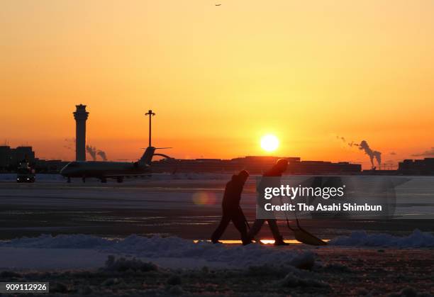 Workers remove snow at Haneda Airport on January 23, 2018 in Tokyo, Japan. The snowstorm affected traffic and public transport in the capital and...