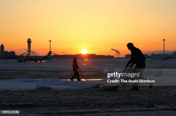 Workers remove snow at Haneda Airport on January 23, 2018 in Tokyo, Japan. The snowstorm affected traffic and public transport in the capital and...