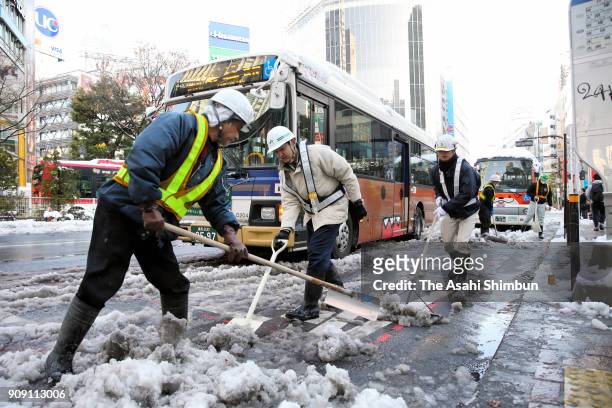 Workers remove snow at Shibuya Station on January 23, 2018 in Tokyo, Japan. The snowstorm affected traffic and public transport in the capital and...