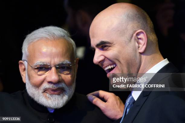 Indian Prime Minister Narendra Modi listens to Swiss President Alain Berset on the opening day of the World Economic Forum 2018 annual meeting, on...