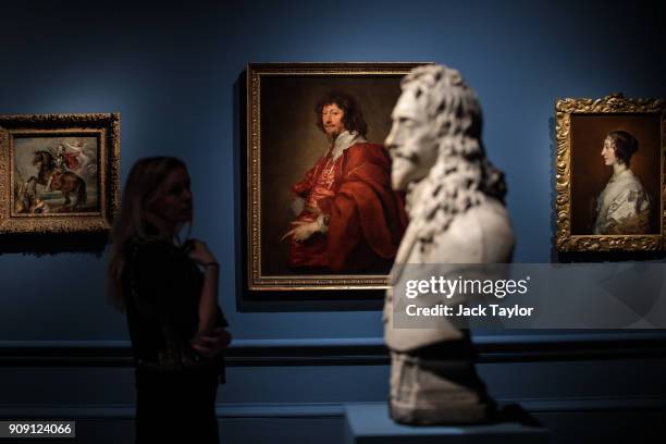 An employee poses with 'Endymion Porter' , 1628 by Anthony van Dyck and the sculpture 'Charles I', 1636 by Francois Dieussart during a press preview...