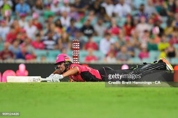 Moises Henriques of the Sixers dives into his crease to avoid being run out during the Big Bash League match between the Sydney Sixers and the...